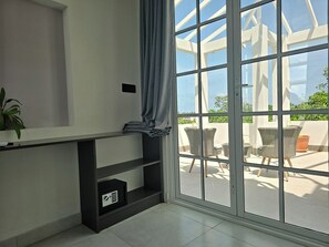 Family Triple Room, Garden View | In-room safe, desk, laptop workspace, blackout drapes