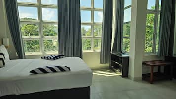 Family Triple Room, Garden View | In-room safe, desk, laptop workspace, blackout drapes