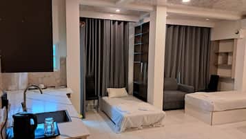 Family Triple Room, Garden View | In-room safe, desk, laptop workspace, blackout drapes