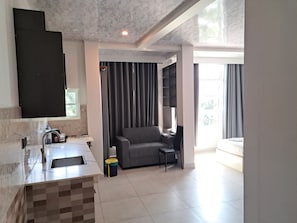 Family Triple Room, Garden View | In-room safe, desk, laptop workspace, blackout curtains