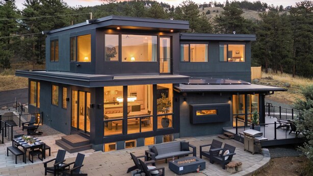 A modern two-story house with a patio area featuring outdoor furniture and a fireplace. - Boulder Luxury: Panoramic Mountain Views, Cedar Hot Tub, Wellness and Romance! (Boulder)