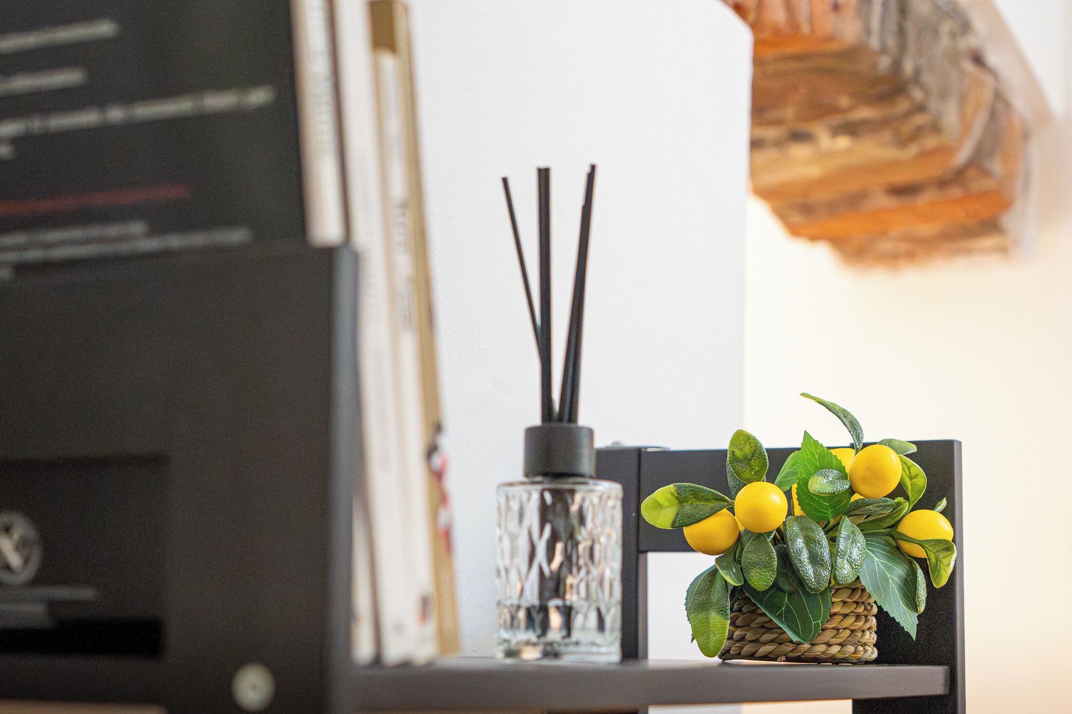 A bookshelf with books and a decorative item.