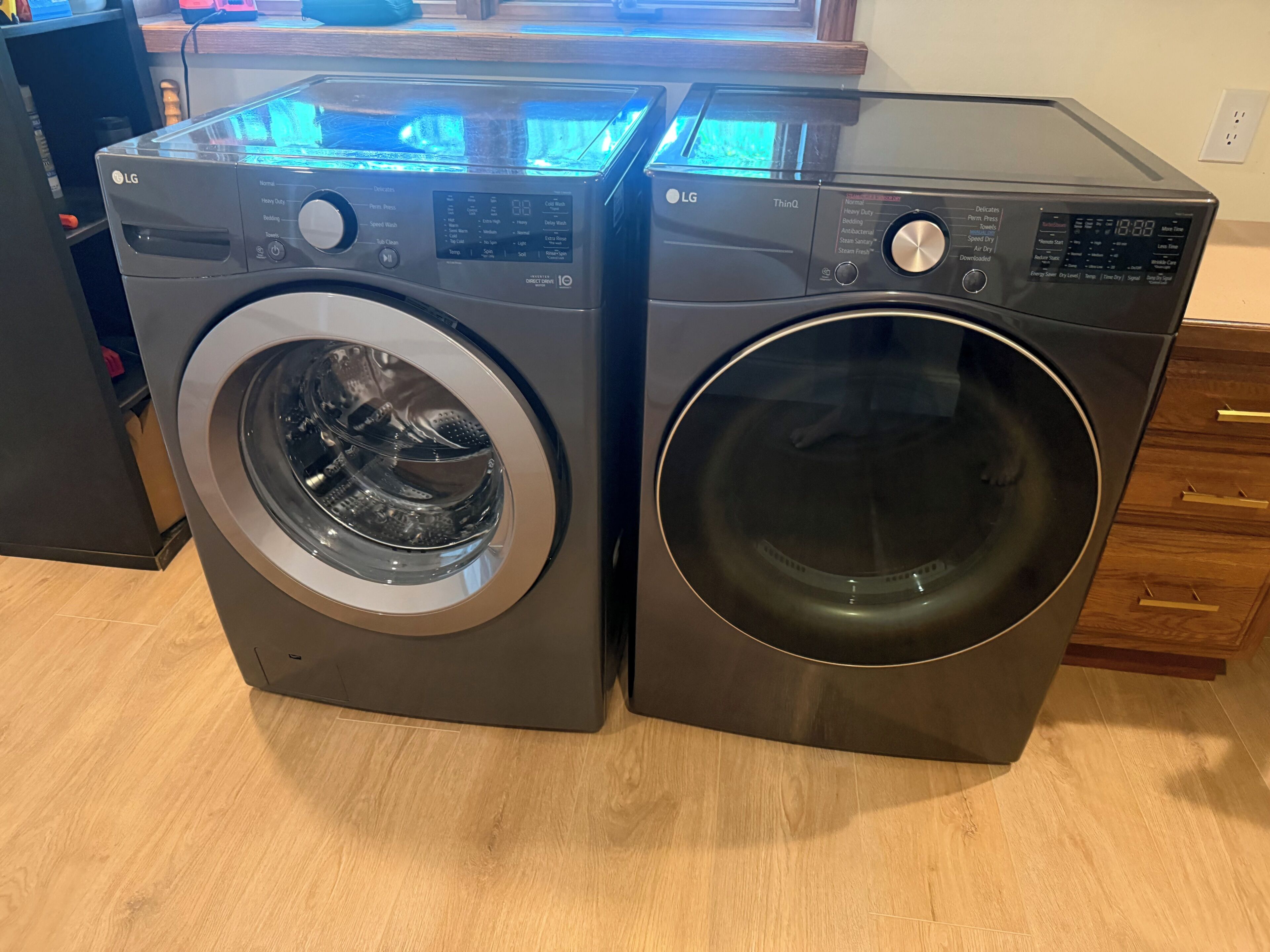 A front-loading washer and dryer unit with control panels, buttons, and a digital display.