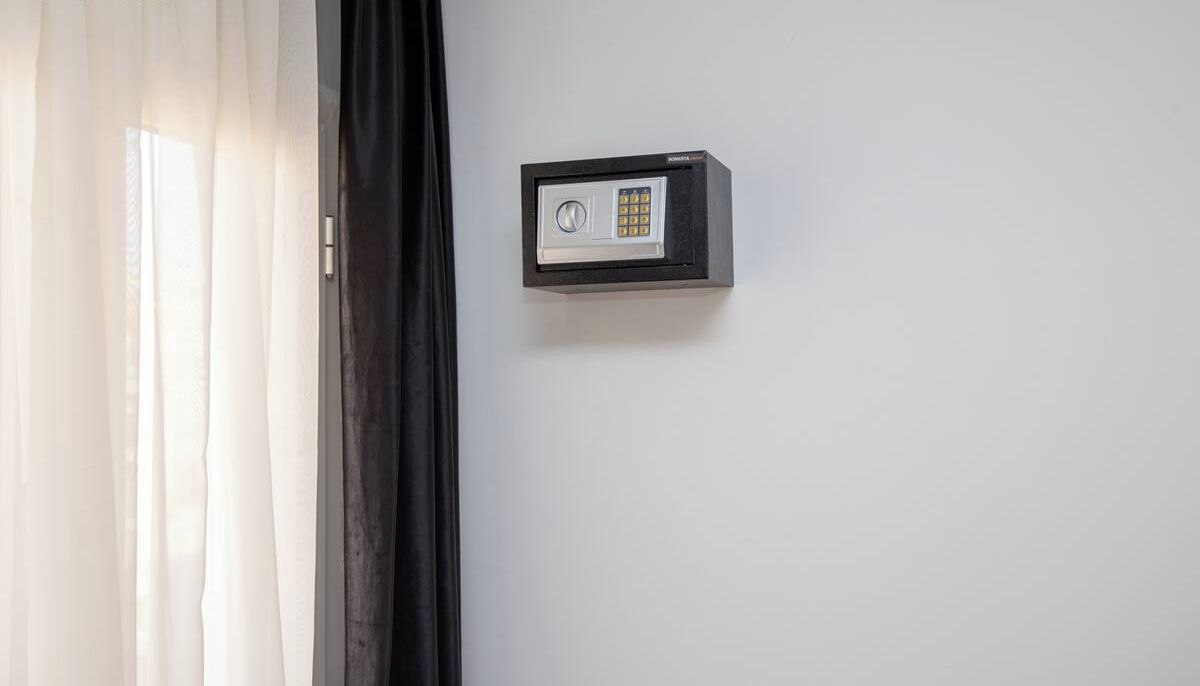 A wall-mounted electronic lock on a white wall.