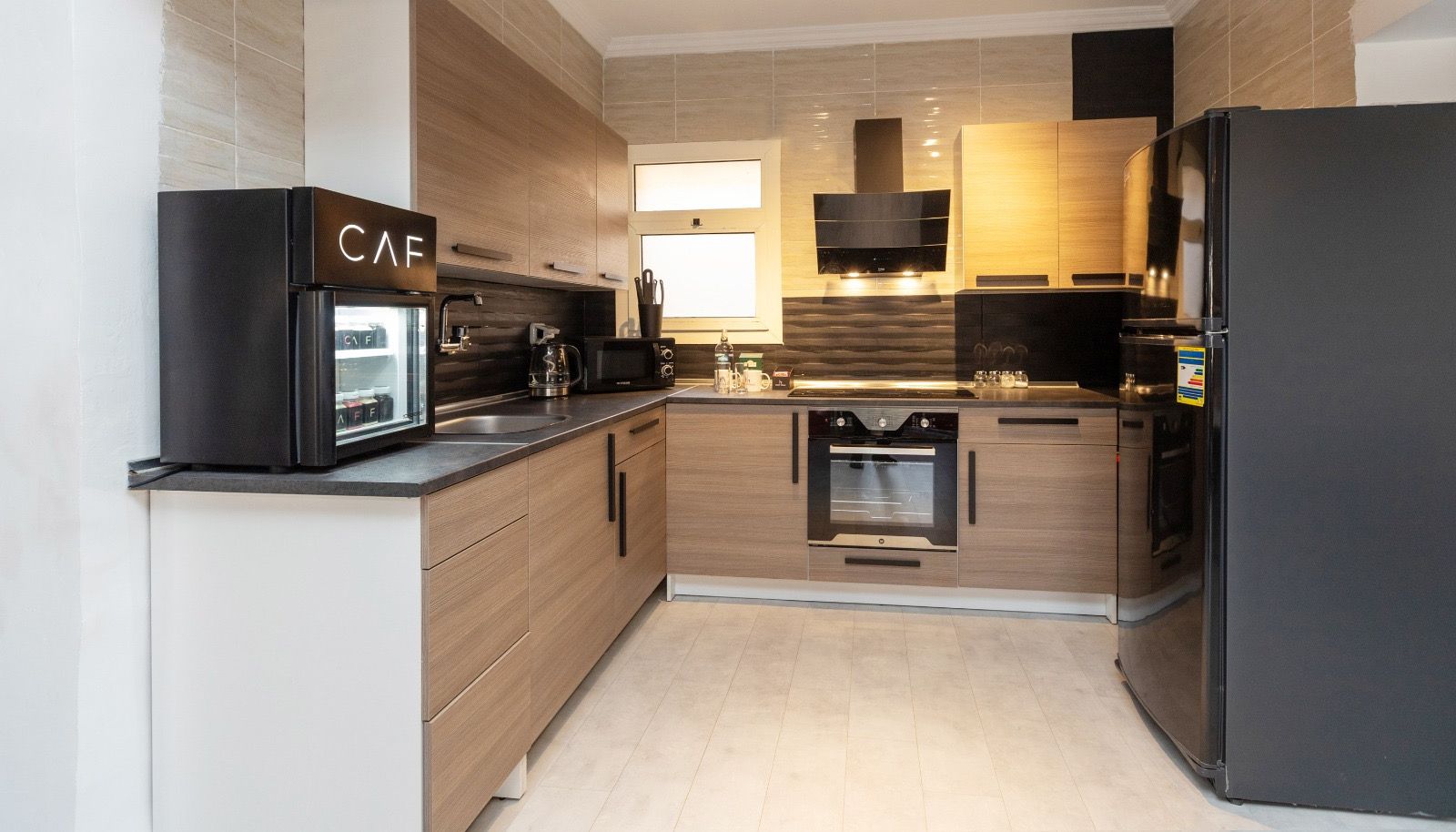 A modern kitchen with a built-in oven, microwave, and coffee maker.