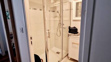 Shower, hair dryer, towels, toilet paper