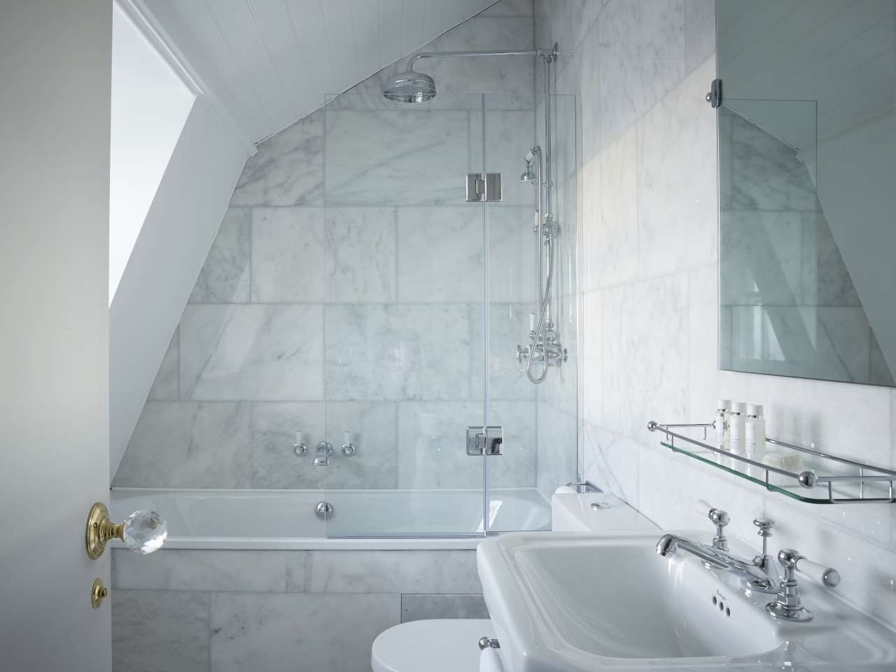 A modern bathroom with a glass-enclosed shower, a freestanding bathtub, and a vanity with a mirror.