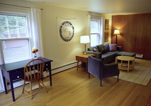 A furnished living room with a desk, chair, sofa, and a lamp. - Cute country escape - Delhi (Delhi)