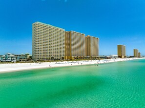 A beachfront hotel with multiple high-rise buildings, a sandy beach, and clear turquoise waters. - Unit 1002 - An updated relaxing 2BR/2BA condo w/private bunk room in Panama City (Panama City)