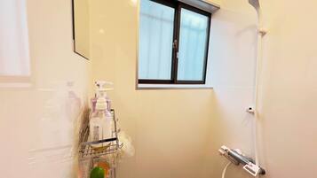 Shower, hair dryer, towels, toilet paper