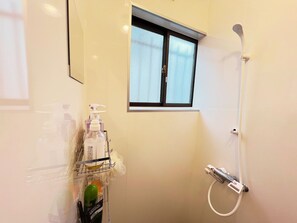 Shower, hair dryer, towels, toilet paper