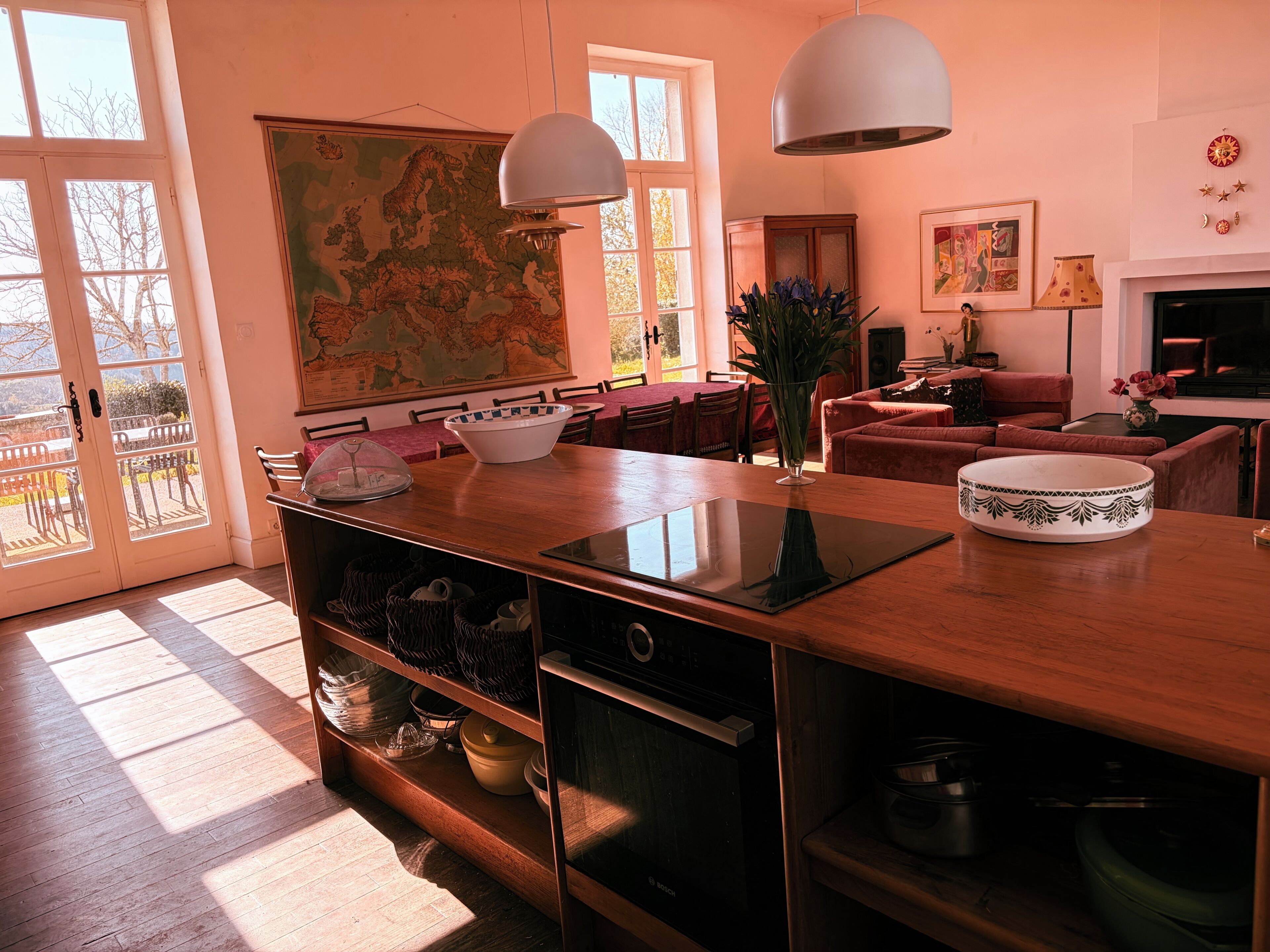A spacious living room with a large map, dining area, and a cozy seating space.
