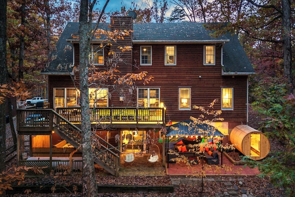 Your three-story mountain retreat, glowing with warmth and ready for unforgettable family time