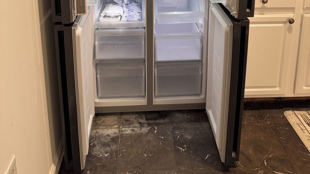 A modern kitchen with a built-in refrigerator, a microwave, and a sink. - Cityscape Retreat In Jersey City. Spacious apt for short and long term stay. (Jersey City)