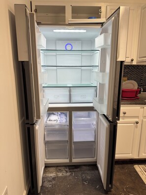 A modern kitchen with a built-in refrigerator, a microwave, and a sink.