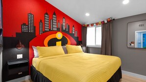 A bed with a yellow quilt, a black nightstand, a red and black cityscape mural, and a window with curtains.