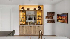 A modern kitchen with wooden cabinets, a marble countertop, and gold faucets. - Welcome to Lucky 13 • Luxurious, private escape on Lake Hills Golf Course. (Billings)