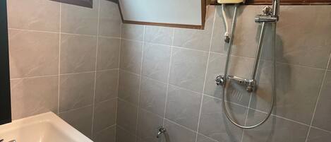 A bathroom with a sink, a shower, and a toilet.