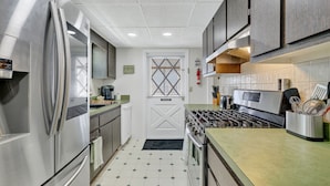 A modern kitchen with stainless steel appliances, a gas stove, and a microwave. - Lake Okeechobee Fishing Retreat (Okeechobee)
