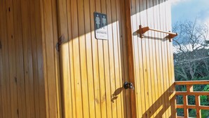 A wooden door with a sign indicating a men's restroom.