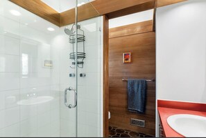 A modern bathroom with a glass shower enclosure, a wooden vanity, and a white sink. - Walking Distance to East Hampton Village, mins to Ocean Beaches (East Hampton)
