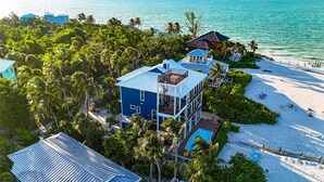 A resort with multiple buildings, a pool, and a beach. - Gran Palacio-Beachfroont,Pool, Fishing & 360 Views, North Captiva Luxury Escape (Lee County)
