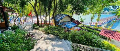 A staircase leading to a covered area with a view of a lake and a boat.