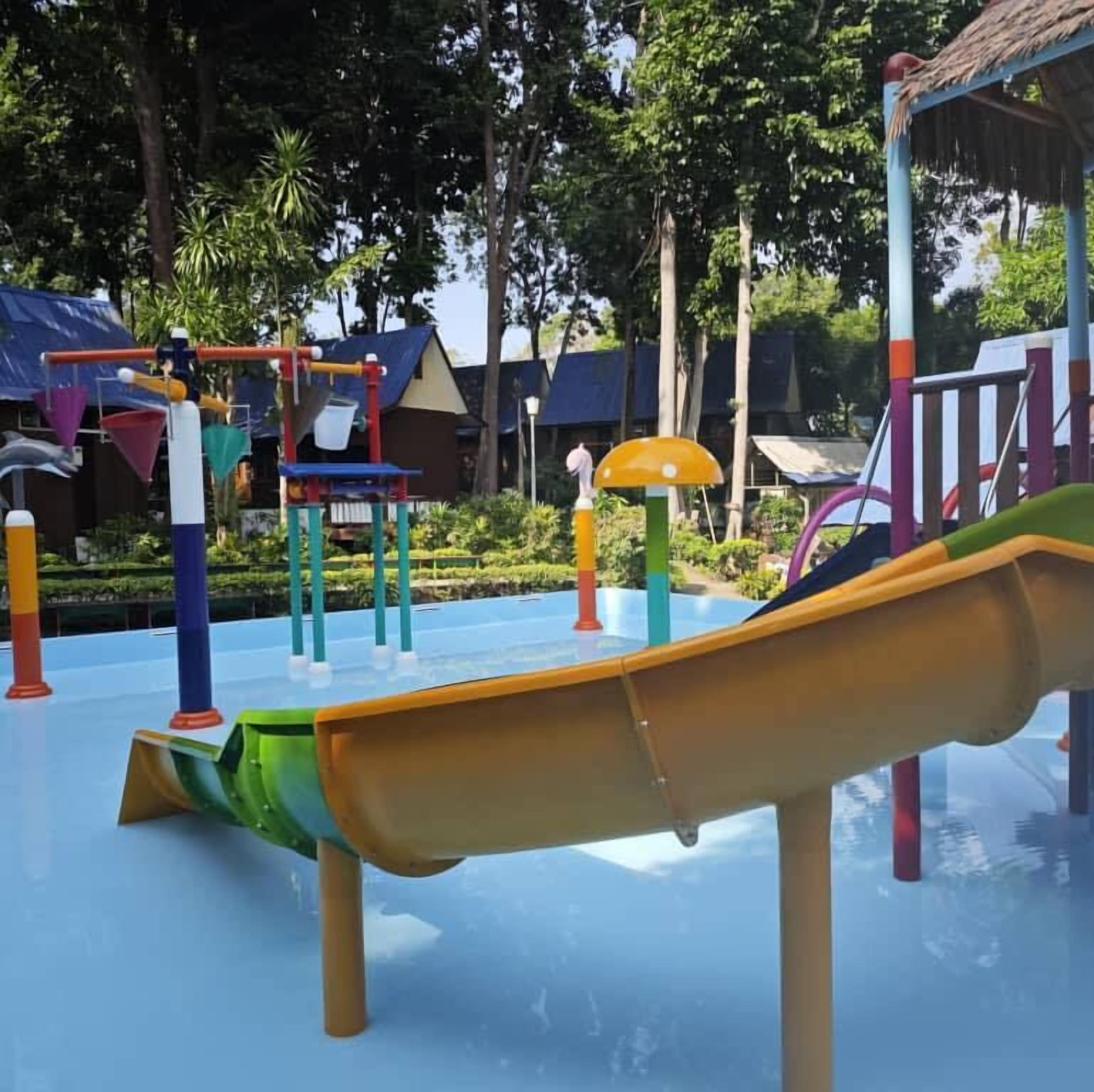 A playground with various play structures including slides and climbing frames.