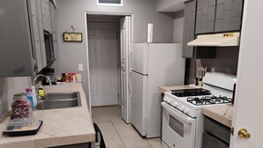 A kitchen with a refrigerator, stove, sink, and cabinets. - 3-bdm home, sunny El Paso near shops, medical, schools, restaurants, & more (El Paso)