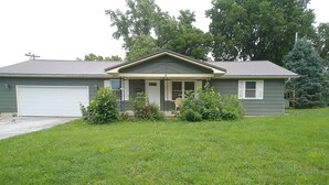 A single-story house with a garage, a front porch, and a well-maintained lawn.