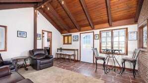 Ein gemütliches Wohnzimmer mit Ledersofas, Steinböden und einer Holzziel.