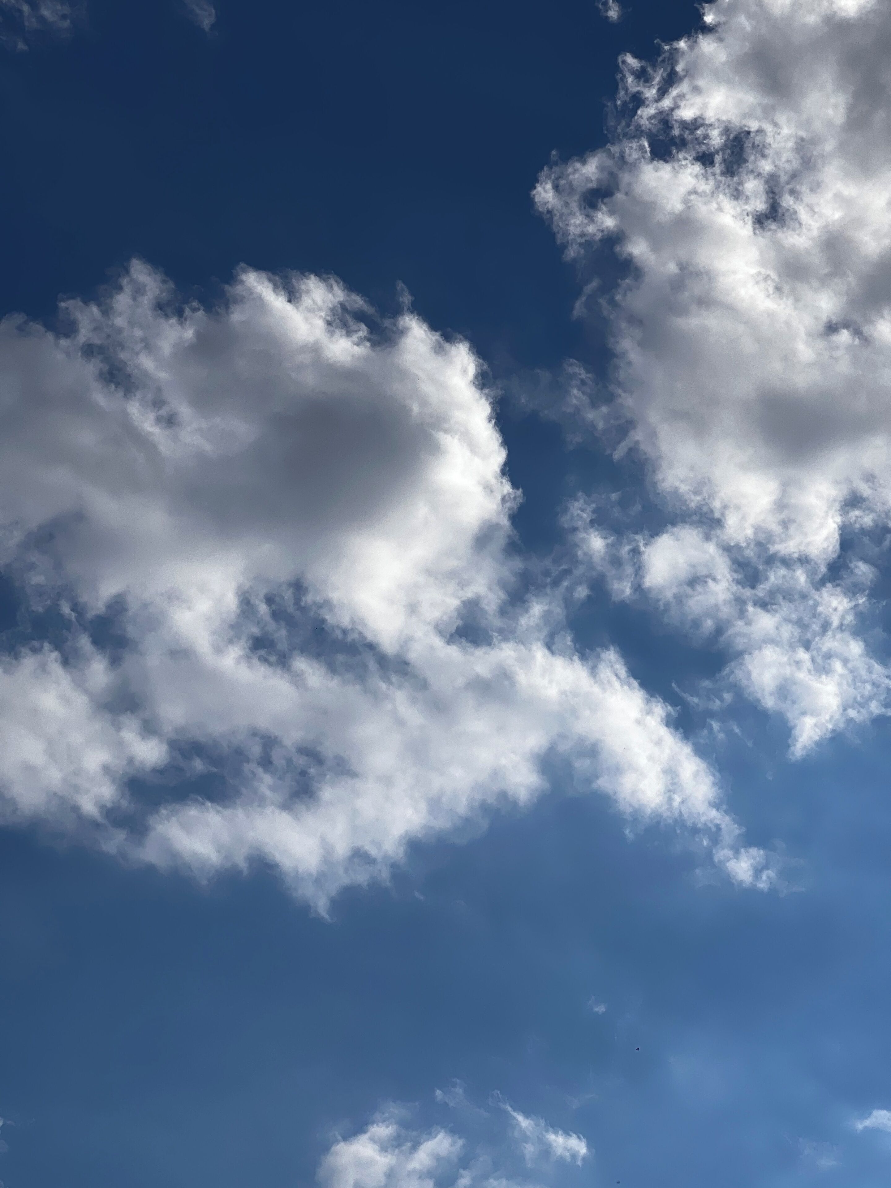 A clear blue sky with scattered clouds.