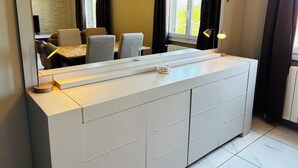 A modern bedroom with a large mirror, a white dresser, and a view of a dining area. - 6-person house with garden in quiet neighborhood (Cournonterral)
