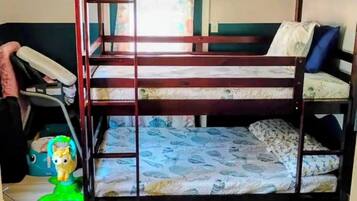 A bunk bed with a wooden frame, a toy horse, and a green toy on the floor.
