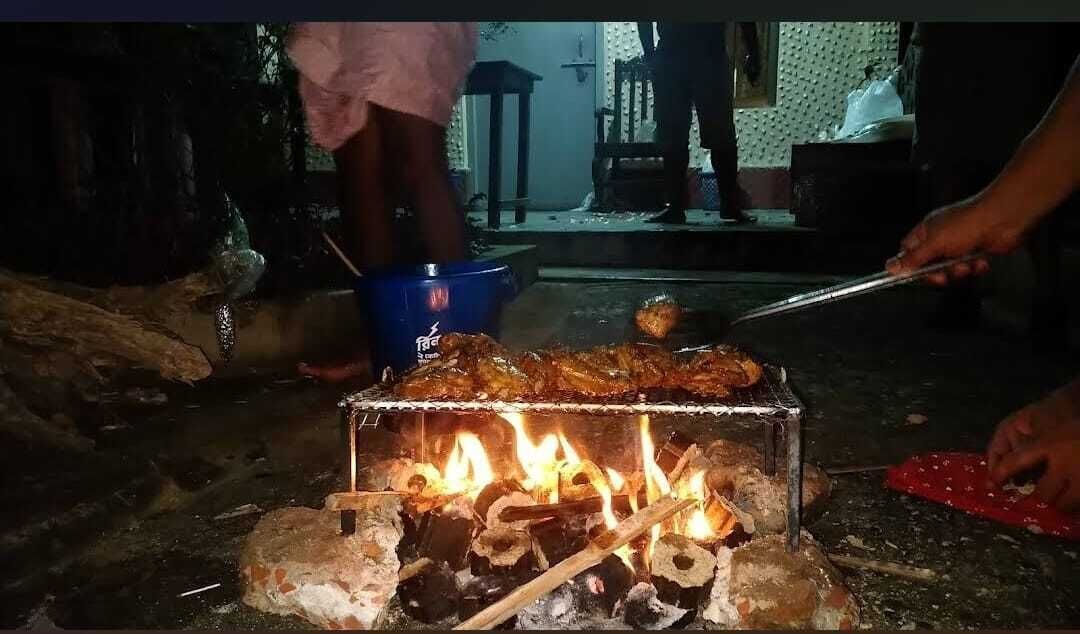 A grill with food being cooked over an open flame.