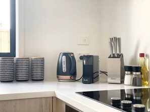 A kitchen with a kettle, a Breville coffee maker, and three patterned containers on the counter. - Salisbury courtyard stay with fibre Wi-Fi in Christchurch (Christchurch)