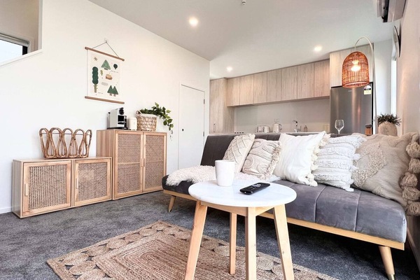 Living area with rattan furniture and the kitchen beyond.