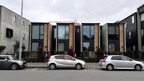 A modern building with large windows and a flat roof.