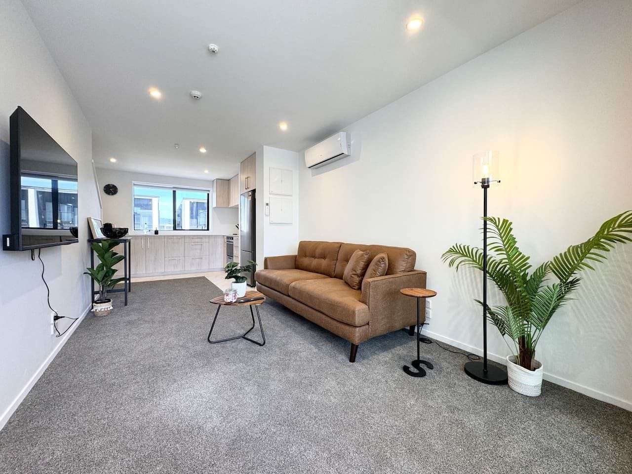 A modern living room with a sofa, a coffee table, and a floor lamp.