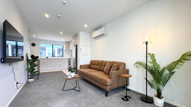 A modern living room with a sofa, a coffee table, and a floor lamp.
