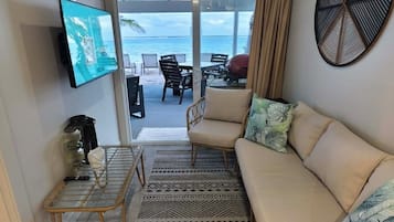 Family Bungalow, 2 Bedrooms, Lagoon View, Beachfront | Living area | 55-inch Smart TV with satellite channels