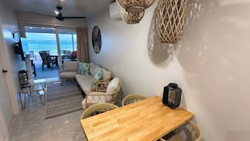 Family Bungalow, 2 Bedrooms, Lagoon View, Beachfront | Living area | 55-inch Smart TV with satellite channels