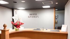 A hotel reception desk with a sign reading "HOTEL LIVEMAX". - HOTEL LiVEMAX Naha Naminoue I (Naha)