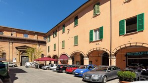 A building with multiple windows and a red awning. - Ciao Bologna Collection - San Martino (Bologna)
