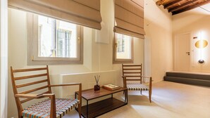 A room with two wooden chairs, a small table, and a mirror on the wall. - Ciao Bologna Collection - San Martino (Bologna)