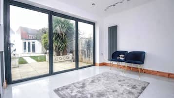 House, 3 Bedrooms | Living area | Flat-screen TV, books