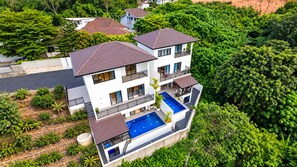 A multi-story residential building with a rooftop pool and balconies.