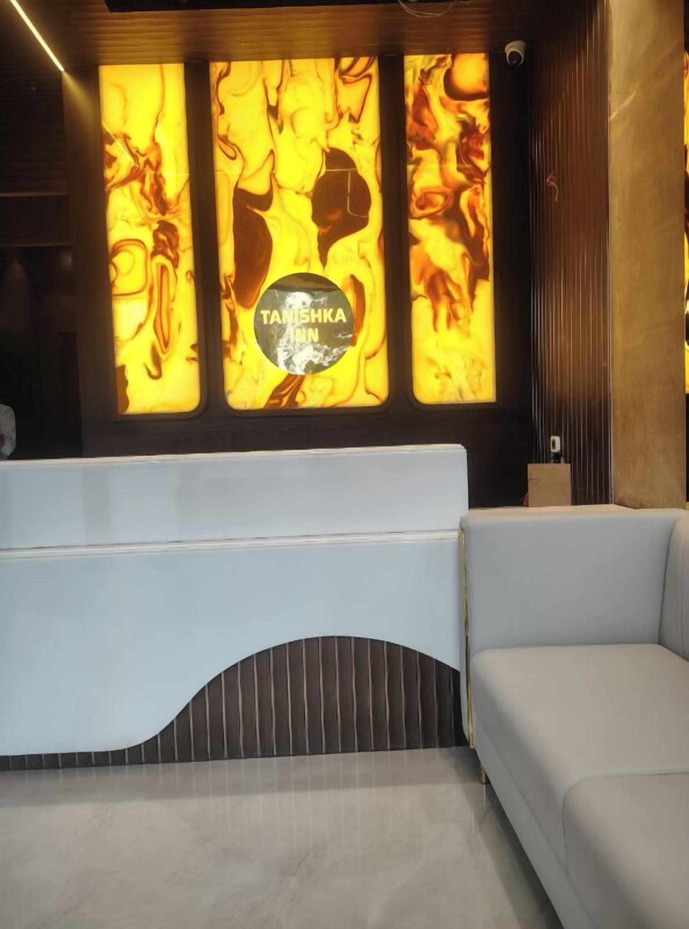 A reception area with a modern design, featuring a reception desk and a seating area.