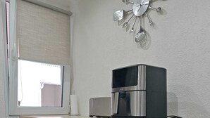 A compact kitchen with a coffee maker, a microwave, a small refrigerator, and a wooden countertop. - Cosy gîte in renovated farmhouse. Spacious bedroom + living room. Pets allowed (Weitbruch)