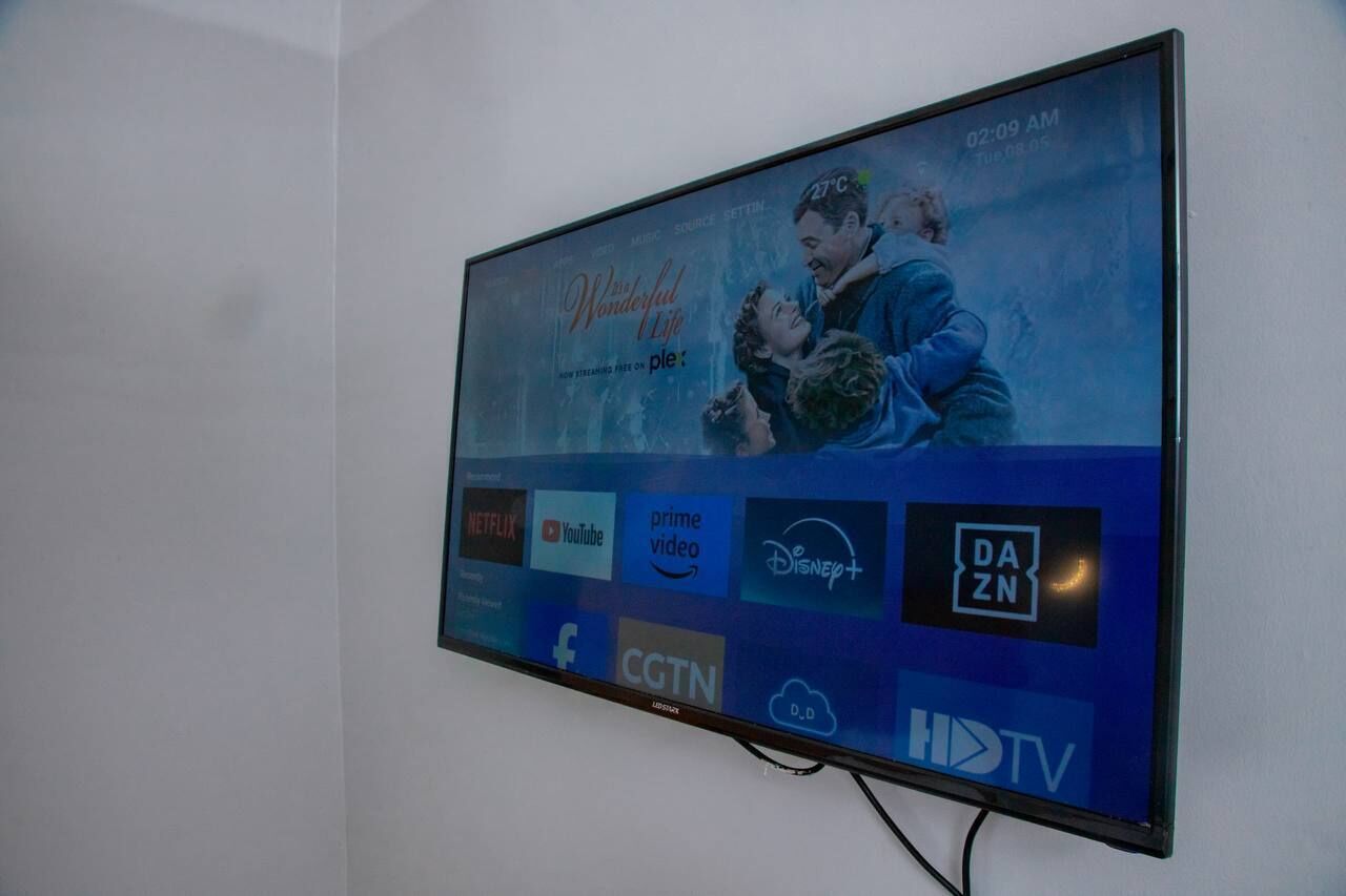 Un televisor mostrando un cartel de la película “Wonderful Life” y varios logotipos de servicios de transmisión.